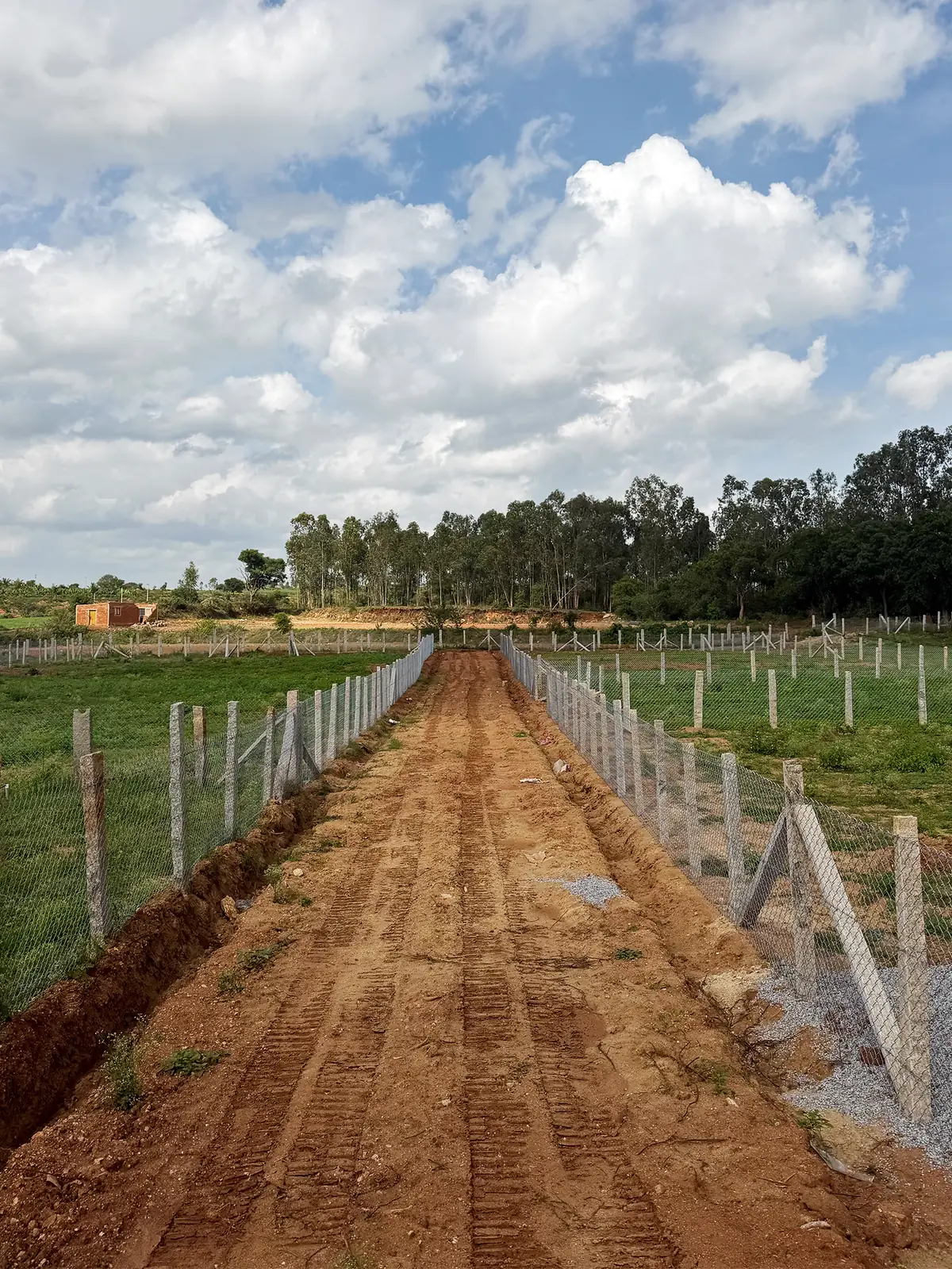 The new access road between fenced farm spaces at ‘No Pin Code Valley’